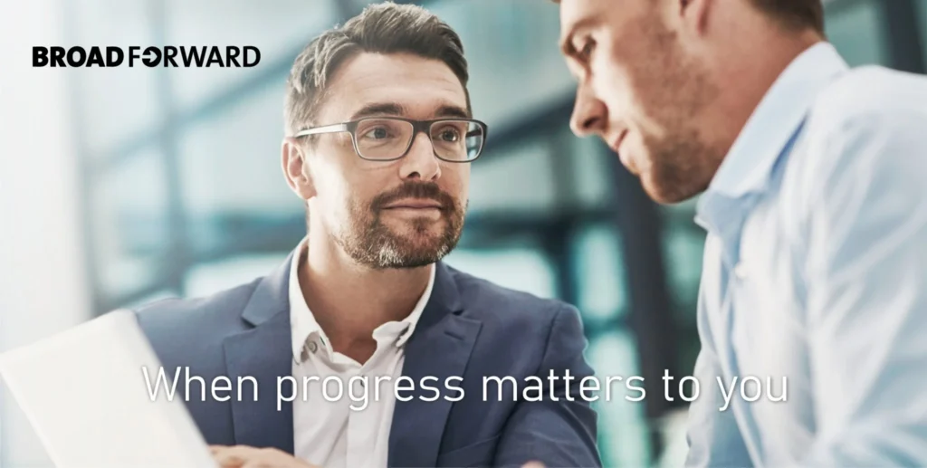 Two men in a business discussion with the text "When progress matters to you."